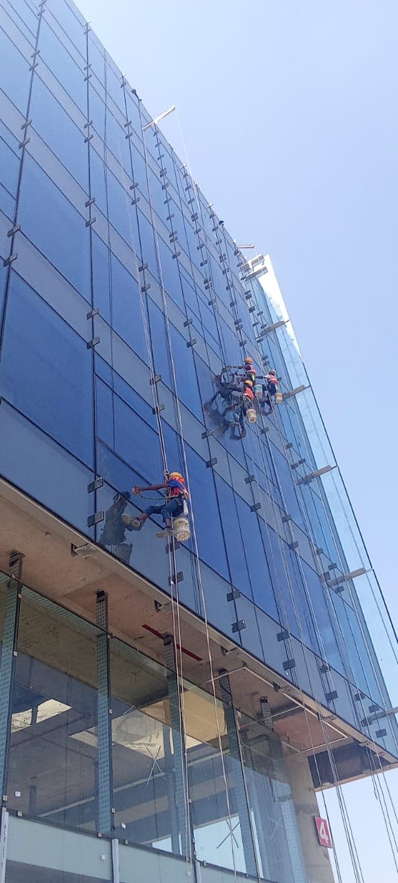 Triple rope technicians descending corporate glass tower